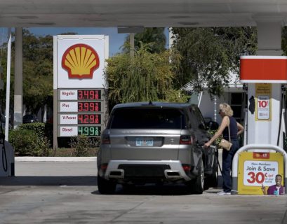 Gas prices rising with oil barrels in background showing energy crisis impact on consumers